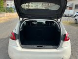 a white car with its trunk open on the street