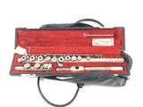a flute that is in a case on a white surface