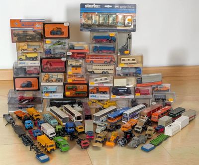 a lot of toy cars and trucks that are on the floor