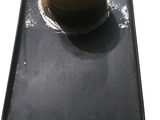 a black tray with a gold knob on it