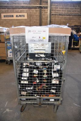 a metal cage filled with bottles of wine in a warehouse