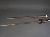 pair of swords with wooden handle and brass fittings on a black surface