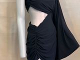 the mannequin is wearing a black dress with a cut out top