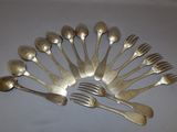 a lot of silver spoons and forks arranged in a circle