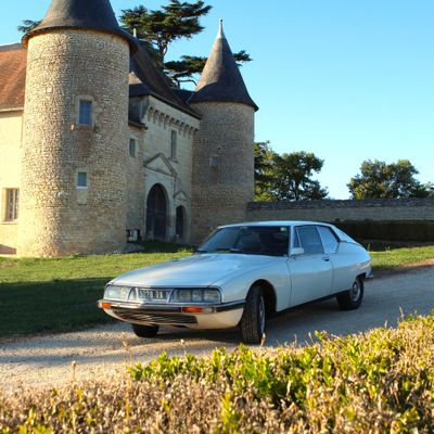 a car that is parked in front of a castle