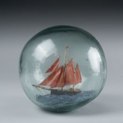 a glass ball with a boat inside of it