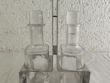 three glasses and a spoon sitting on a table