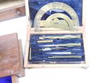 a wooden box with a set of tools in it