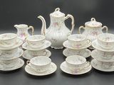 a picture of a table setting with a tea pot and cups
