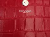 a close up of a red purse with a button on it
