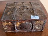 a small wooden box on a table with a tag on it