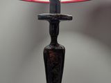 a lamp that is sitting on a table with a lamp shade on it