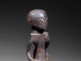 an image of a statue of a man holding a guitar