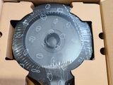 a box with a clock inside of it on the floor