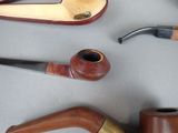 many different types of smoking pipes on the table