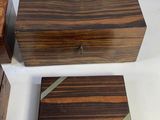 three wooden boxes are sitting next to each other on a white surface