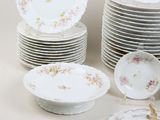a lot of plates and bowls that are sitting on a table