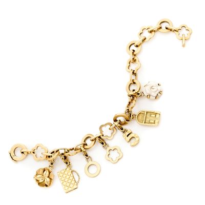 a close up of a gold bracelet with charms on it