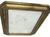 an image of a gold framed mirror on a white wall