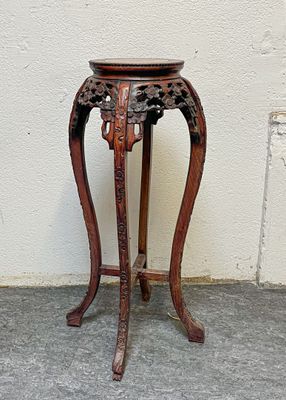a small wooden table with a vase on top of it