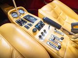 a yellow car dashboard with a steering control panel