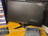a desk with a monitor, keyboard, mouse, and cell phone on it