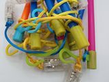 a pile of different colored toothbrushes on a white surface
