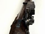 a close up of a gun on a white surface with a white background