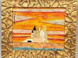tableau représentant un château dans un cadre doré, avec un coucher de soleil en arrière-plan