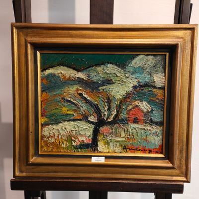 une peinture représentant un arbre au milieu d'un tableau posé sur un chevalet