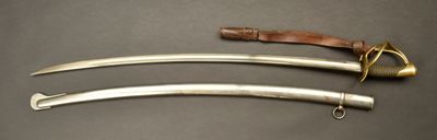 two knives are sitting on a table with a leather strap