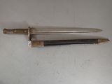 a knife and a pencil on a table