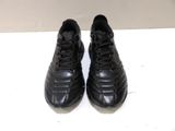 pair of black leather soccer shoes on a white surface
