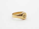 a gold signet ring with a skull on it