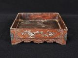 an old wooden box with a metal handle on a black background