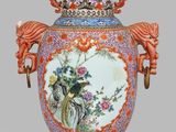 a vase with a handle that has a painting on it