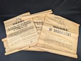 three old papers are sitting on a table with a black background
