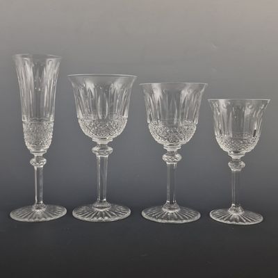 four wine glasses are lined up in a row on a table