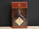 a bottle of liquor sitting in a box on a table