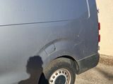 a shadow of a person standing in front of a van