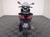 a motorcycle that is parked in a room with a checkered floor