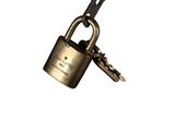 a close up of a metal padlock with a key attached to it