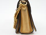 the small black and gold purse has a chain hanging from it ' s handle