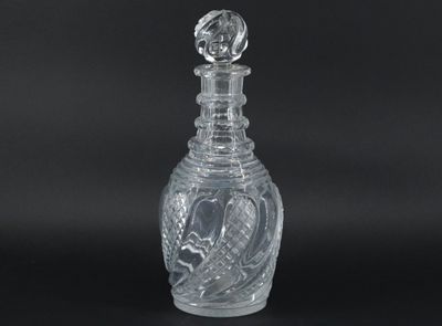 clear glass decanter with a bird on the top of it