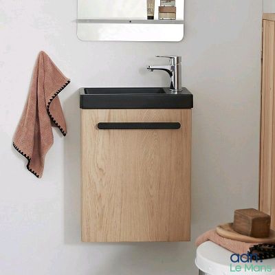 a bathroom with a sink, mirror and a towel rack