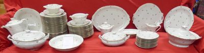 many plates and bowls on a red table cloth
