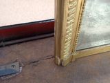 a broken mirror on the floor in front of a window