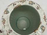 a cup and saucer sitting on a white table