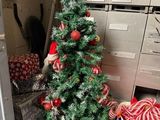 a small christmas tree in the corner of a room