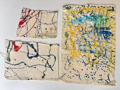 three pieces of art are on a white surface with blue and yellow paint